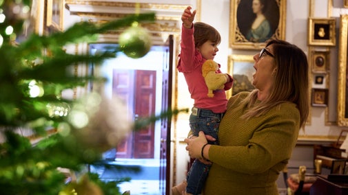 Visitors enjoying the Christmas decoration in the house at Hatchlands Park, Surrey